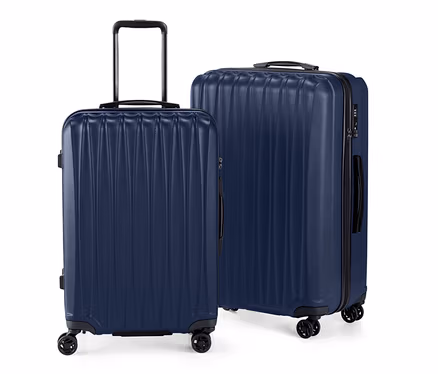 Un lot de valises rigides, grande et petite, bleu marine, debout sur un fond blanc.