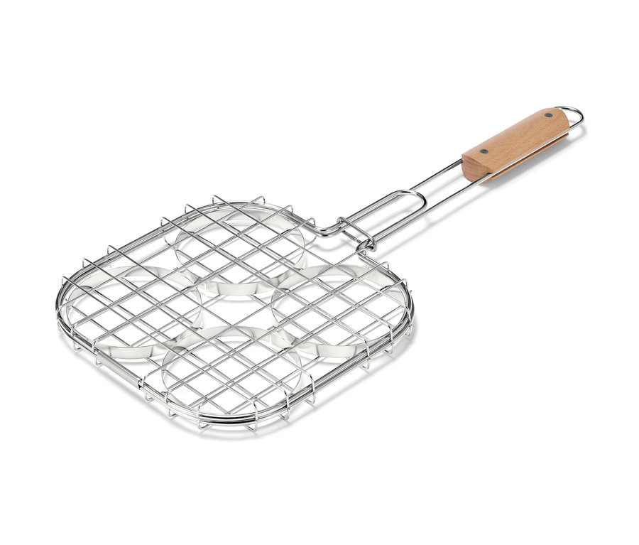 Spatule à burger pour barbecue avec quatre cavités rondes et manche en bois.