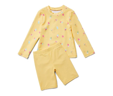 Combinaison jaune pour enfants avec indice de protection UV 80, imprimée de motifs de glaces.