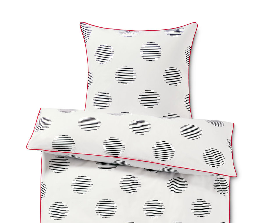 Parure de lit en percale blanche taille normale avec des cercles noirs et une bordure rouge.