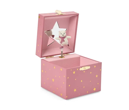 Boîte à musique rose avec des étoiles dorées, ouverte, montrant un ours polaire blanc avec une écharpe rose et des patins, debout sur un mécanisme. Le couvercle a un miroir en forme d'étoile.