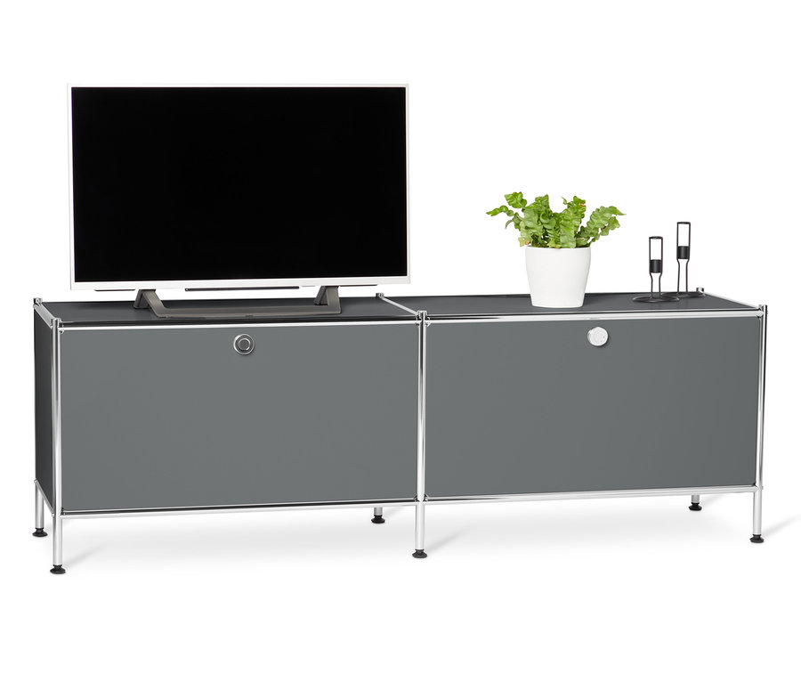 Téléviseur posé sur un meuble bas en métal « CN3 » gris à abattants.