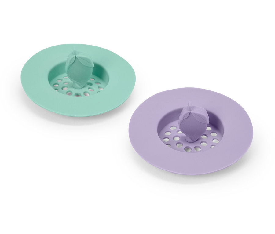 Deux bouchons d'évier en silicone : un vert menthe et un violet.