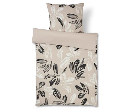 Linge de lit à motif floral beige et noir avec taie d'oreiller assortie.