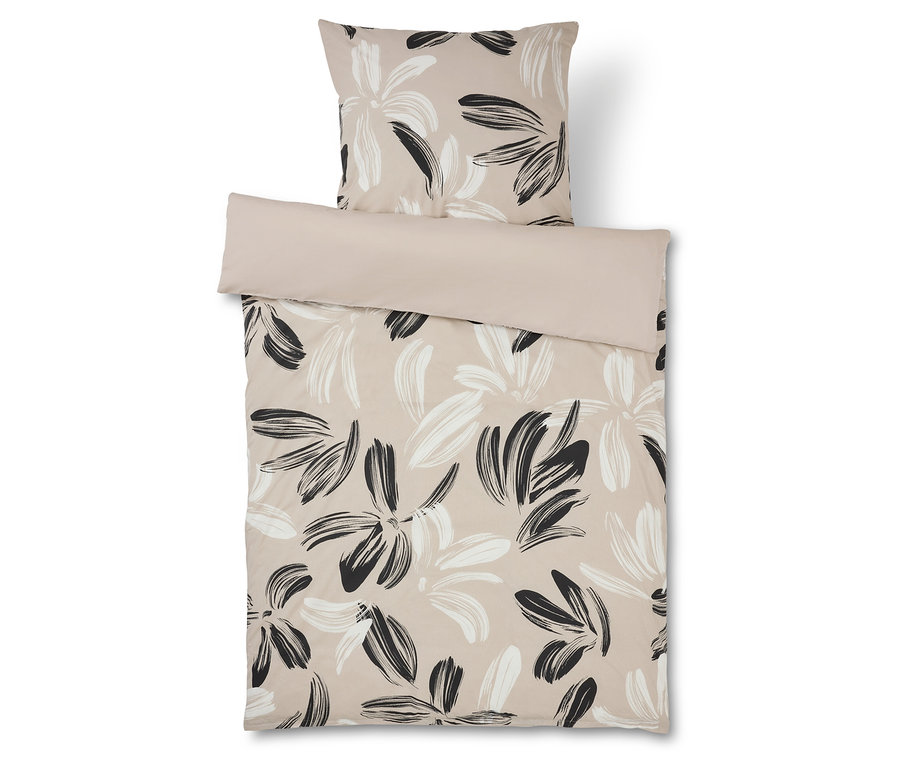 Linge de lit à motif floral beige et noir avec taie d'oreiller assortie.