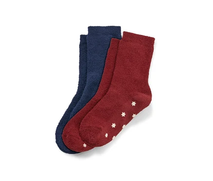 Deux paires de chaussettes moelleuses pour enfant, une bleu foncé et une bordeaux avec des étoiles blanches.