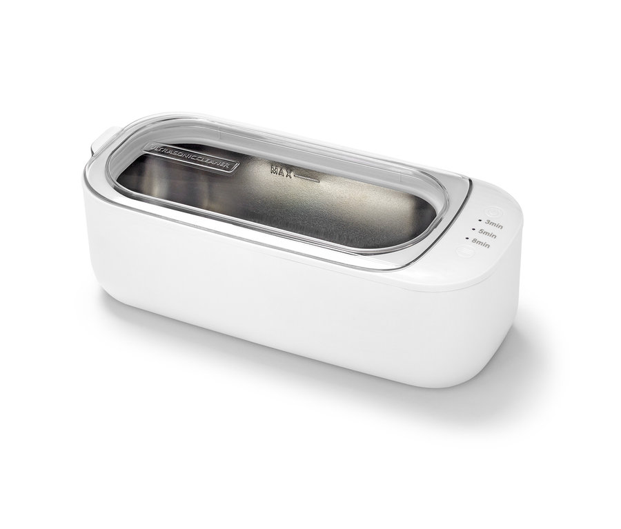 Nettoyeur à ultrasons blanc avec couvercle transparent.