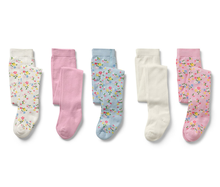 Cinq collants pour enfant, à motif floral, en blanc, rose et bleu.
