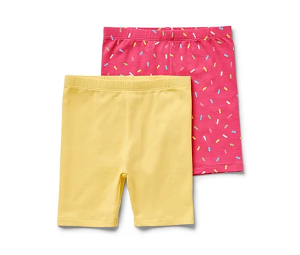 Deux leggings de cycliste pour enfant, un rose et un jaune.
