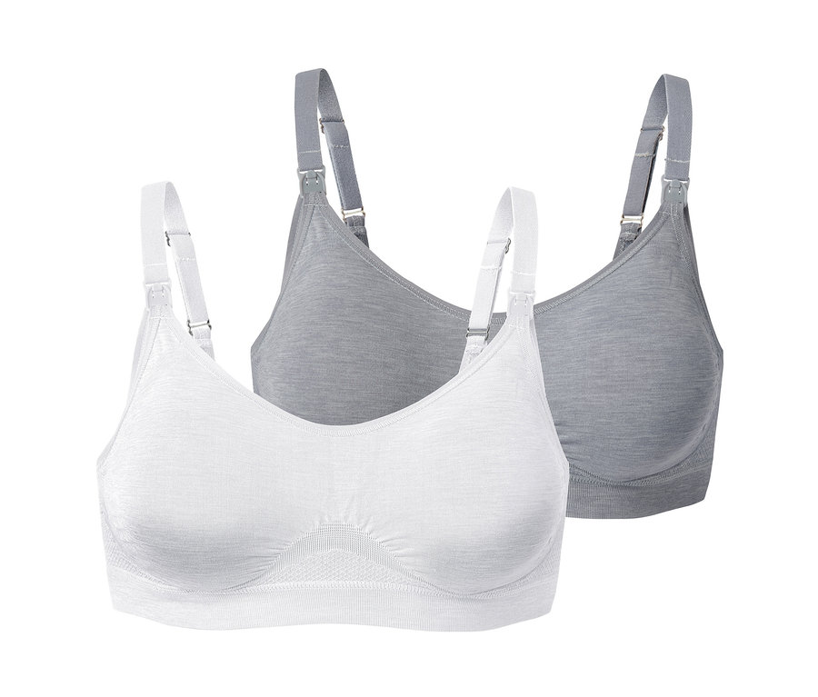 Deux soutiens-gorge d’allaitement sans coutures, un blanc et un gris, avec des bretelles blanches.
