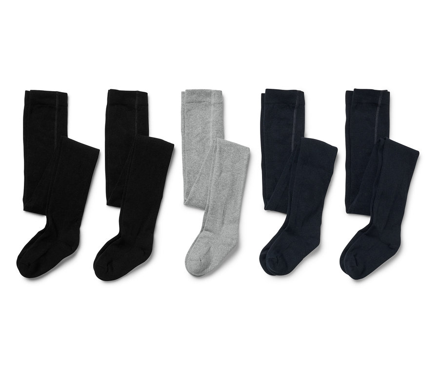 Cinq paires de collants pour enfants en noir, gris et bleu marine posés sur un fond blanc.