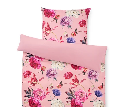 Linge de lit à fleurs rose comprenant une taie d'oreiller et une housse de couette.