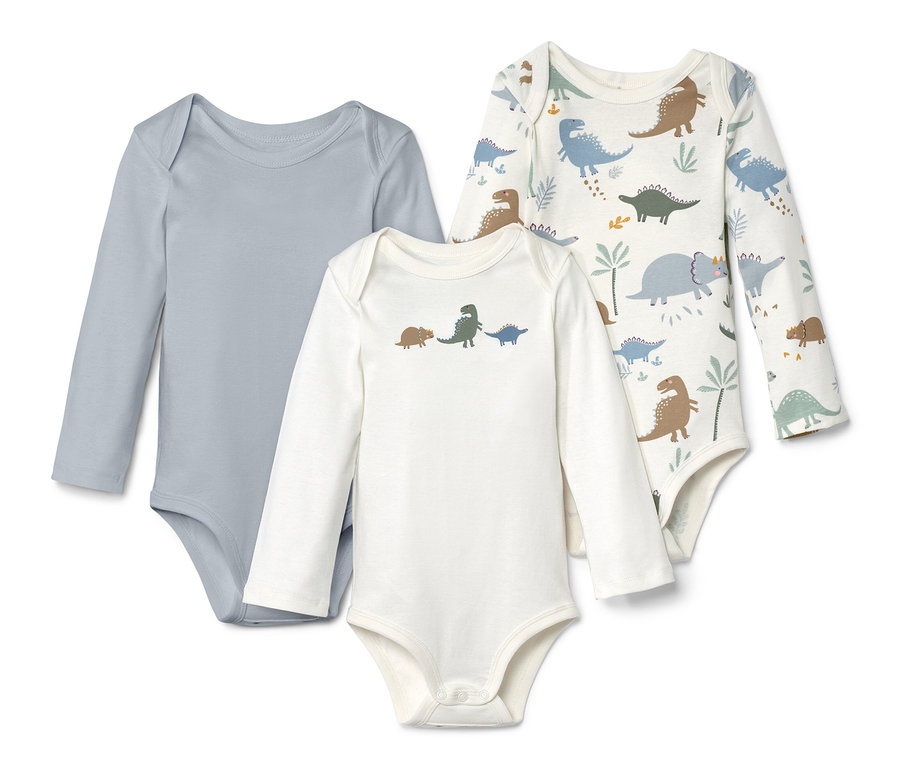Trois bodies à manches longues : un gris, un blanc avec des dinosaures et un blanc avec un motif de dinosaures.