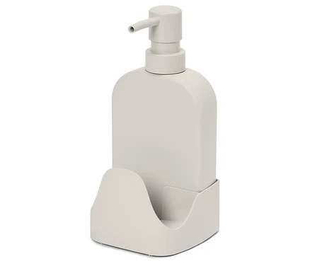 Un distributeur de savon beige avec une pompe, posé dans un support assorti.