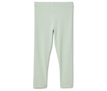 Un legging vert clair posé sur un fond blanc.