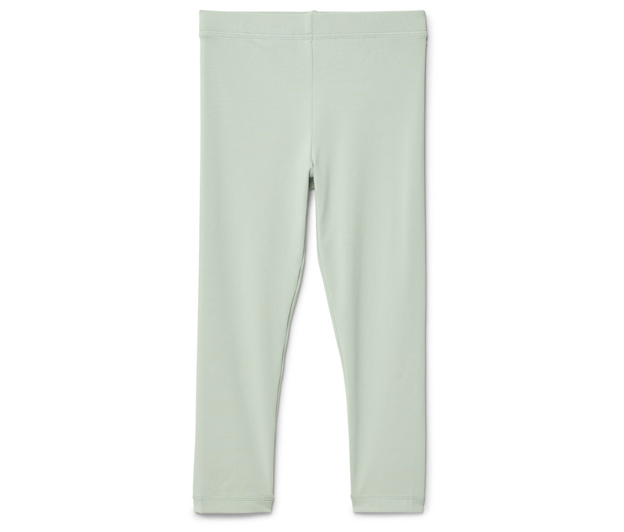 Un legging vert clair posé sur un fond blanc.