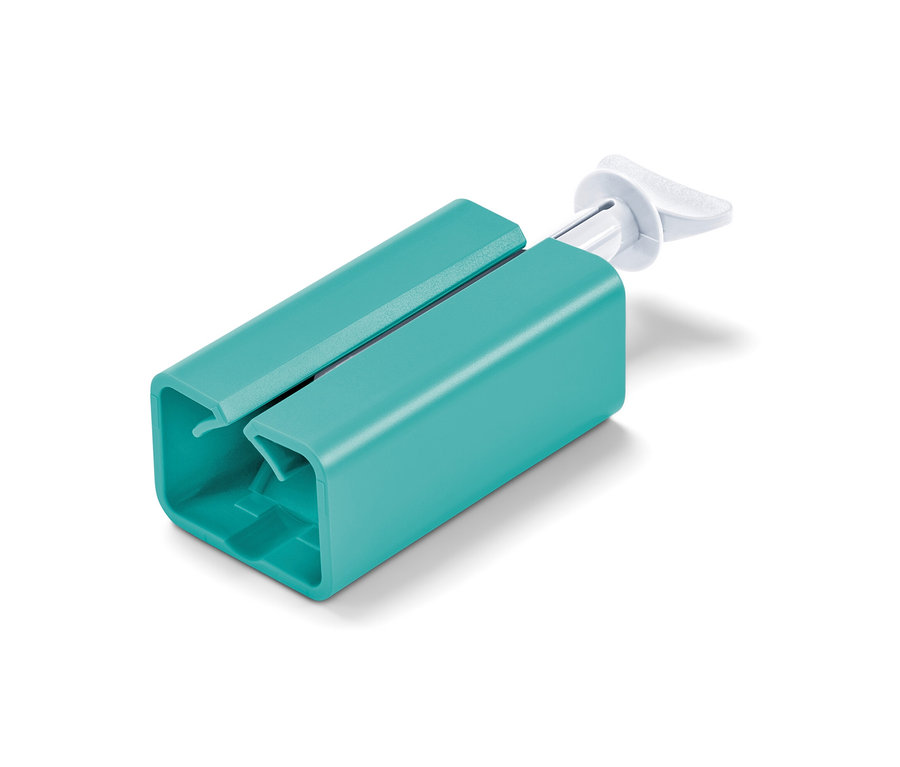 Vue rapprochée d'un presse-tube sur un fond blanc.