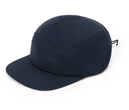 Casquette bleu marine à visière plate posée sur un fond blanc.