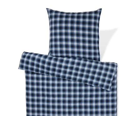 Linge de lit à carreaux bleus avec oreiller.