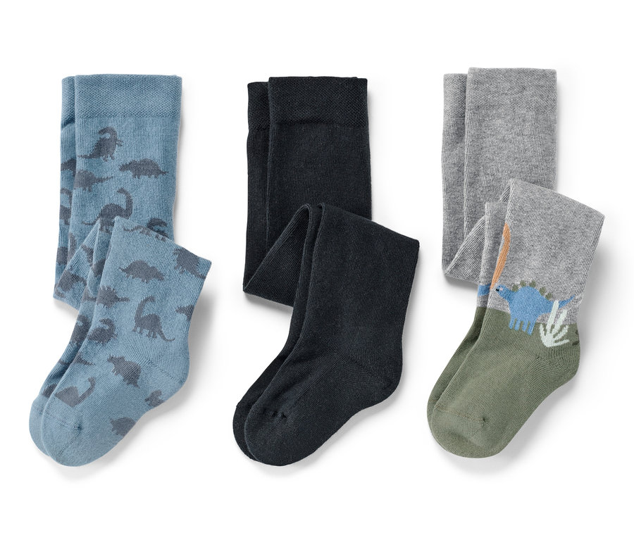 Trois paires de collants pour bébé : bleu avec des dinosaures, noir et gris avec un motif de dinosaure.