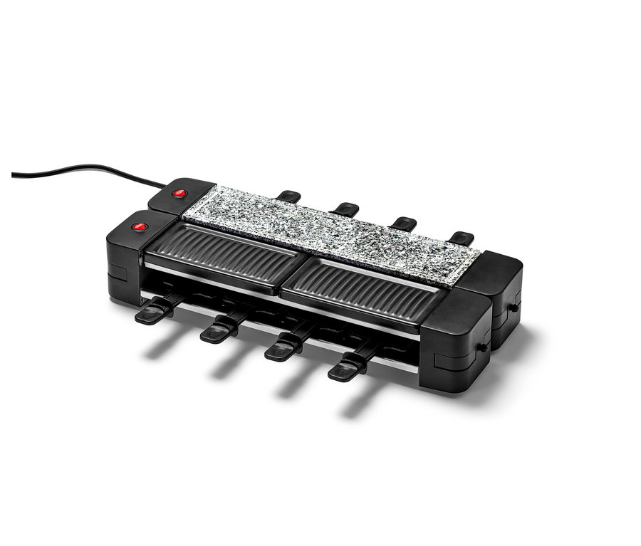 Gros plan sur un appareil à raclette pliable noir avec une plaque en granit gris et huit poêlons.