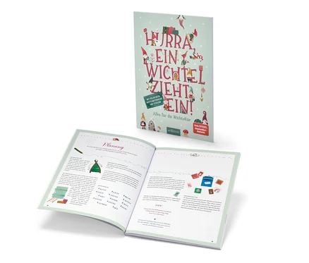 Le livre « Hurra, ein Wichtel zieht ein! » (en allemand) est ouvert et se trouve derrière.