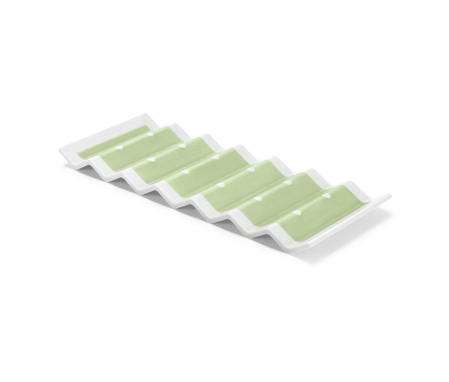 Support à bouteilles pour le réfrigérateur, blanc avec surfaces intérieures vert pastel.