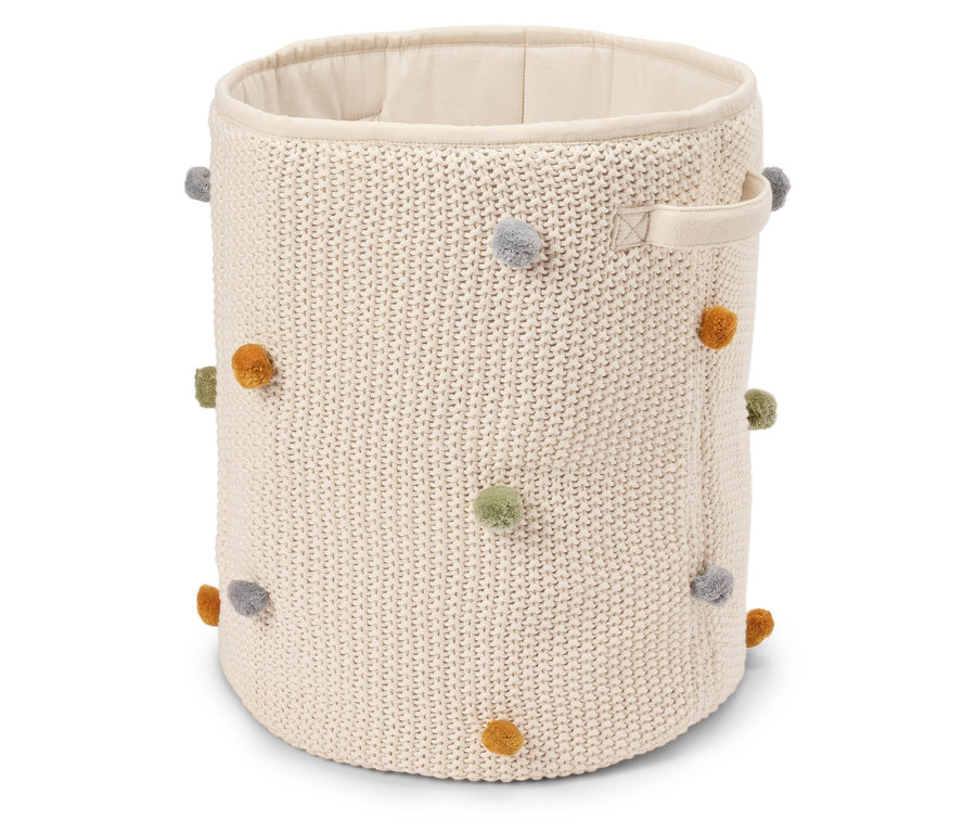Panier à tricoter rond beige avec des pompons colorés et deux poignées.