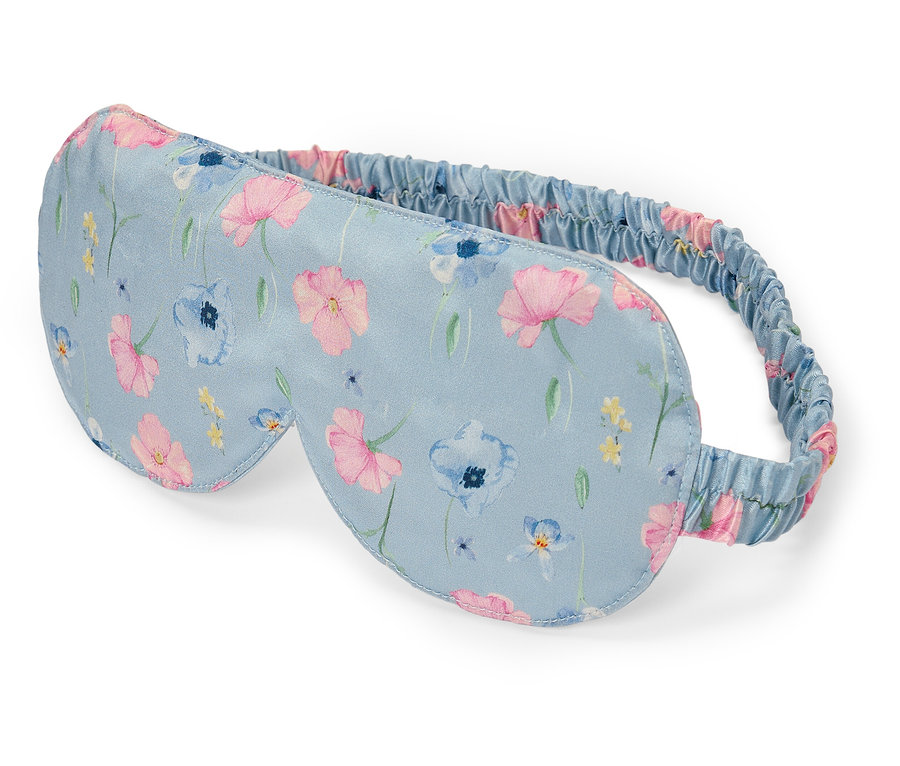 Masque de sommeil bleu clair à motifs floraux.