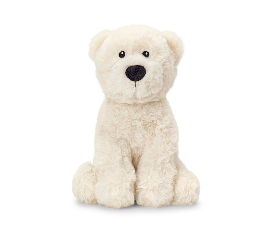 Une peluche ours polaire est assise sur un fond blanc.