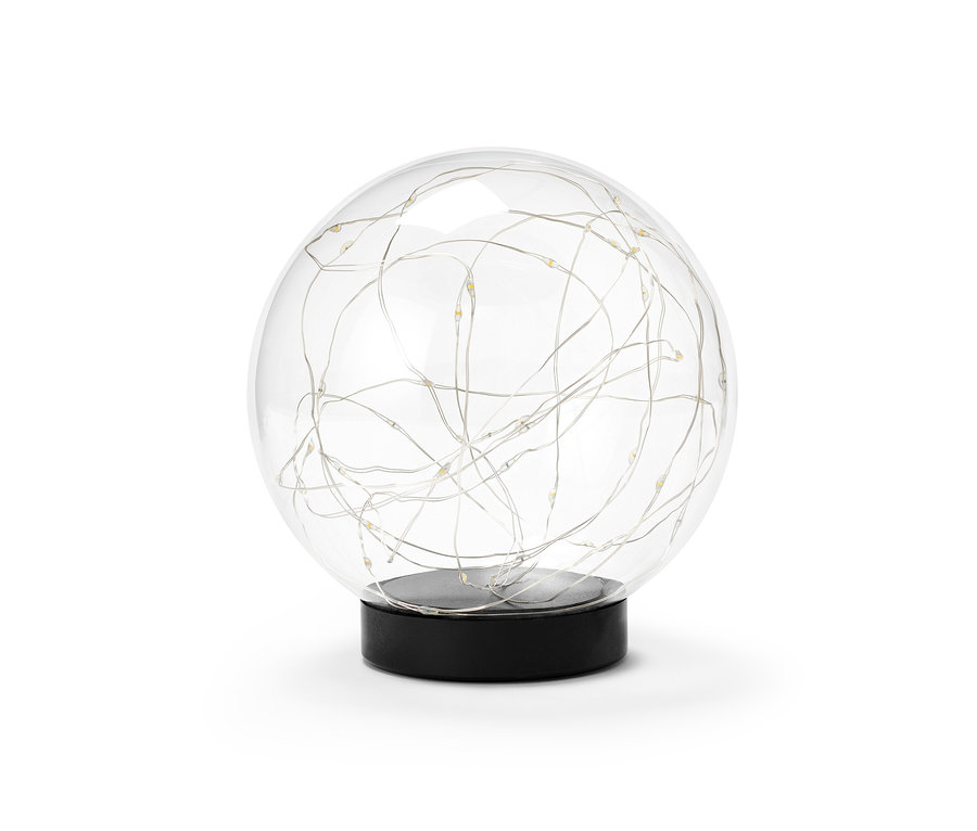 Une boule de verre à LED d'environ 15 cm posée sur un socle noir.