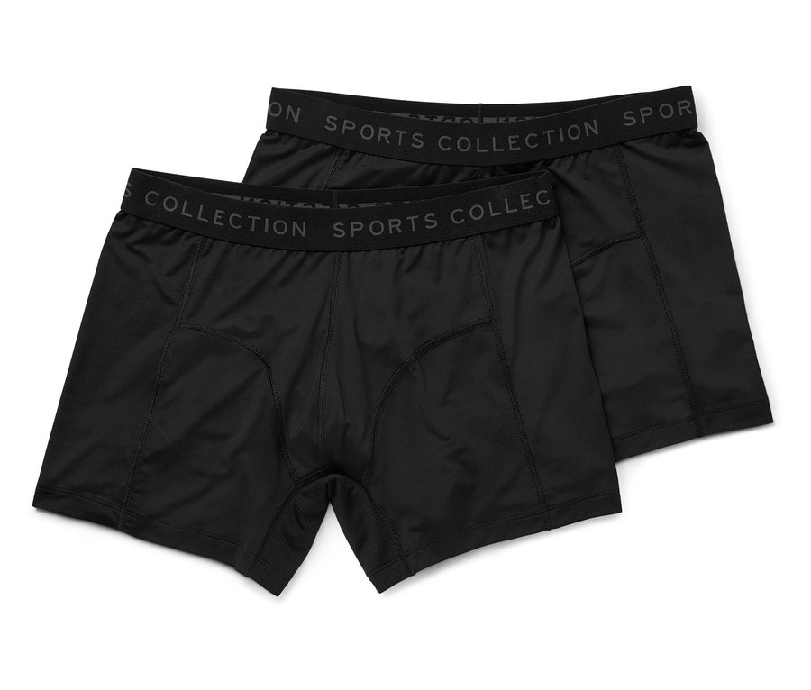 Deux boxers noirs pour hommes reposent sur un fond blanc.