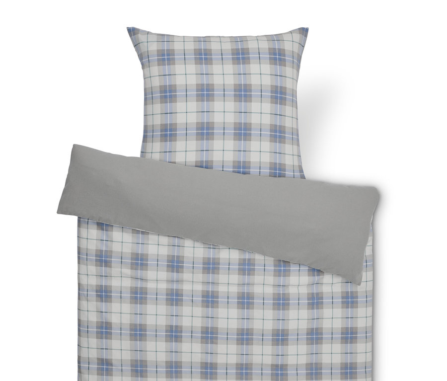 Un ensemble de literie à carreaux avec une taie d'oreiller grise.