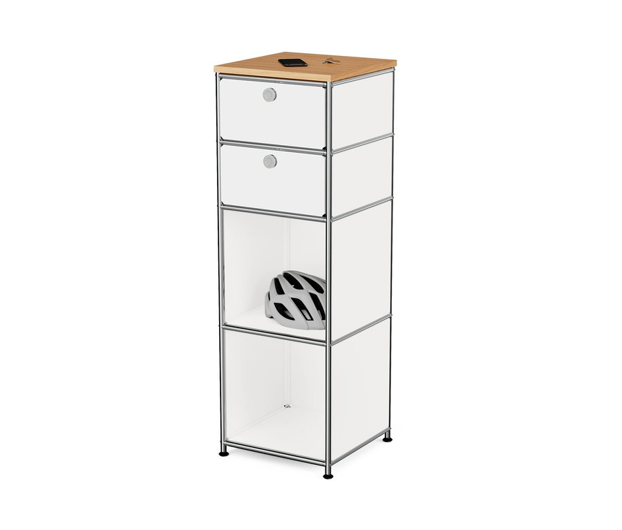 Commode étroite en métal blanc « CN3 » avec plateau en bois et 2 tiroirs. Un casque blanc est visible dans un compartiment ouvert.