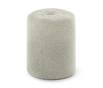 Pouf cylindrique tapissé d'un tissu bouclé texturé beige clair, avec une légère indentation sur sa surface supérieure.