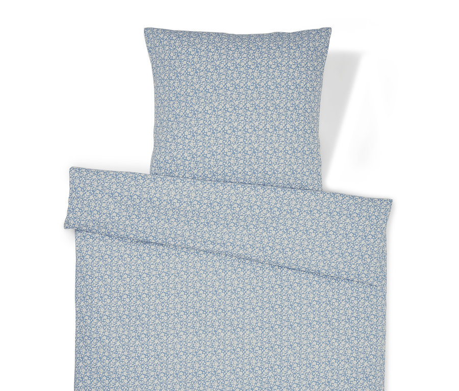 Linge de lit à motif floral et oreiller.