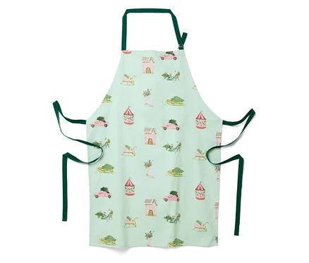 Tablier vert clair avec un motif de Noël de maisons, voitures, traîneaux et carrousels.